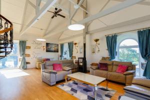 a living room with two couches and a table at The Old Chapel in Camborne