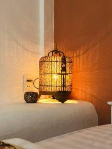 a room with a bed with a lamp on a table at Gem Villa 67, biệt thự 15 phòng có hồ bơi lớn in Ho Chi Minh City