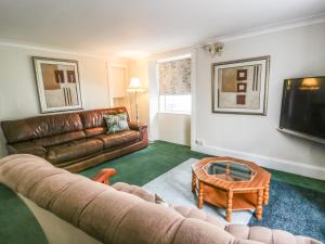 a living room with a couch and a coffee table at Portland in Brodick