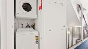 a laundry room with a sink and a washing machine at Razorback 6 in Mount Hotham