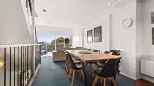 a dining room with a wooden table and chairs at Razorback 6 in Mount Hotham