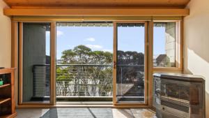a room with a large glass window with a view at Razorback 7 in Mount Hotham