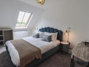 A bed or beds in a room at The Mabel Suite Stone Cross Mansion