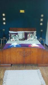 a bedroom with a wooden bed with pillows at Apartment Pereybere in Grand-Baie