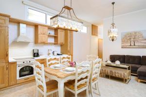 a kitchen and living room with a table and chairs at Luxury House Niso in Skala Sotiros