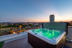 a hot tub on a balcony with a view at PANORAMA DELUXE APARTMENT in Zadar