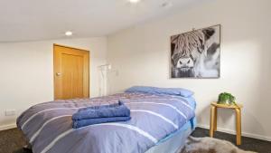 a bedroom with a bed with blue towels on it at Shamrock 3 in Mount Hotham