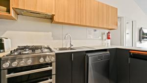 a kitchen with a stove and a sink at Shamrock 3 in Mount Hotham