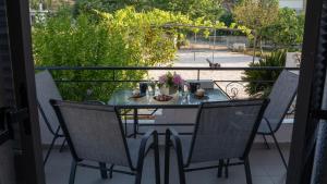 a table with a vase of flowers on a balcony at Sivotahomes-family in Syvota