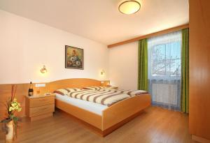 a bedroom with a large bed and a window at Wurzerhof in Racines