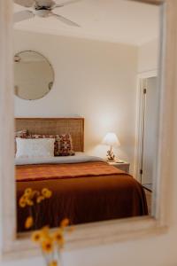 a bedroom with a bed and a mirror at Captain John's River House in Goolwa North