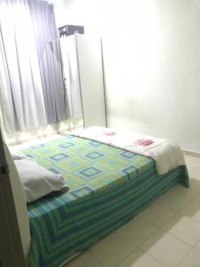 a small bed in a room with a window at Maryam kiara kerteh homestay in Kertih