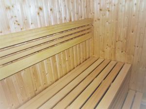 a wooden bed in a sauna at Guest House LUFT Sněžník in Sněžnik
