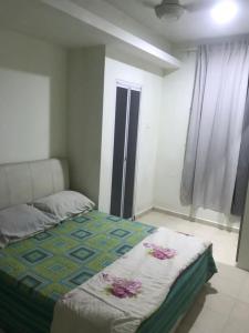 a bedroom with a bed in a room at Maryam kiara kerteh homestay in Kertih