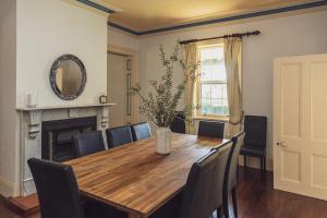 a dining room with a table and chairs and a mirror at CLAYFIELD HOMESTEAD - rustic country accommodation in Bishopsbourne