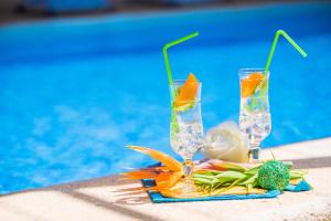 two glasses on a towel next to a swimming pool at Cal Tio in Sa Pobla