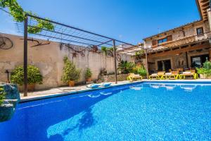 a swimming pool in front of a house at Cal Tio in Sa Pobla