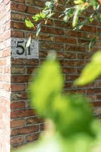 a brick wall with a number on it at Cosy Guestroom Bruges in Bruges