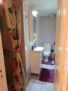 a small bathroom with a sink and a toilet at Central Square appartment with panoramic view in Kalamata