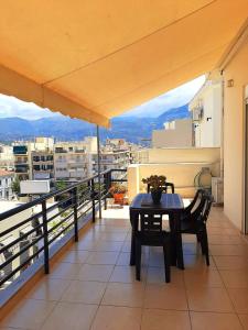 a table and chairs on a balcony with a view at Central Square appartment with panoramic view in Kalamata