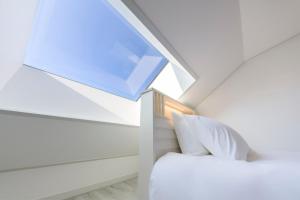 a room with a bed and a skylight at Liverpool & Spa in Jeju