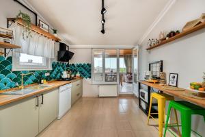 a kitchen with white cabinets and green accents at Dualis Hotel in Istanbul
