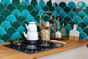 a kitchen counter with a stove and a green and blue wall at Dualis Hotel in Istanbul +176 photos