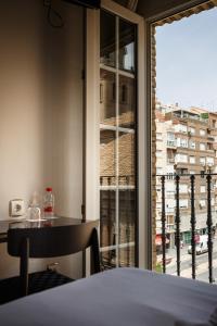 a room with a window with a view of a city at Hotel Dauro Premier in Granada