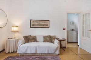 a white bedroom with a bed and a table at Casa Parco Casale in Rapallo