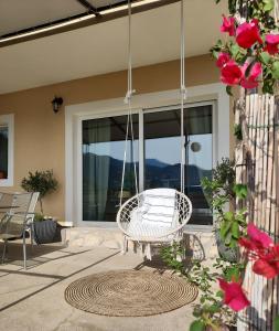 a porch with a swinging chair on a patio at Apartman ELLA in Peračko Blato +41 photos