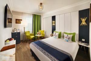 a hotel room with a bed and a dining area at Hotel Ephesus Istanbul in Istanbul