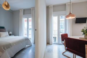 Łóżko lub łóżka w pokoju w obiekcie Guadalquivir Terrace Suite Apartments