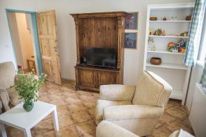 a living room with two chairs and a television at Chalupa Brod nad Dyjí in Brod nad Dyjí