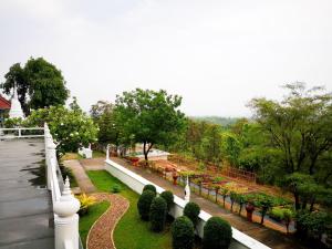 a view of a garden with bushes and trees at Amaravati Wellness Center SHA Plus in Mae Rim