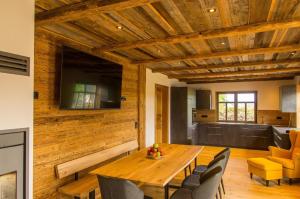 uma sala de jantar com uma mesa de madeira e cadeiras em Chalet am Ölberg mit Badefass und Altholzsauna em Waldmünchen