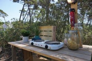 a stove sitting on a wooden table with food at Pigna Felice Punta Ala in Punta Ala