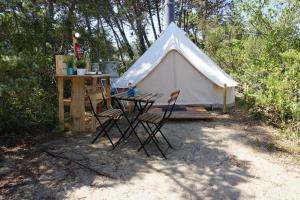 a tent with chairs and a table in front of it at Pigna Felice Punta Ala in Punta Ala