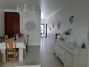 a kitchen and dining room with a table and chairs at Beach Falésia in Albufeira