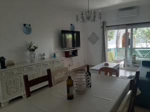 a dining room with a table with a bottle of wine on it at Beach Falésia in Albufeira