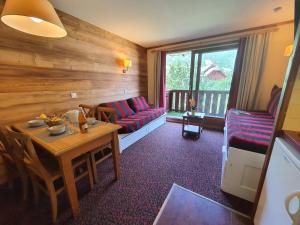 a living room with a couch and a table at L'Alpaga by Mountain Collection Immobilier in La Salle-les-Alpes