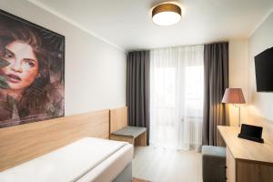 Postel nebo postele na pokoji v ubytování Arthotel ANA Eden