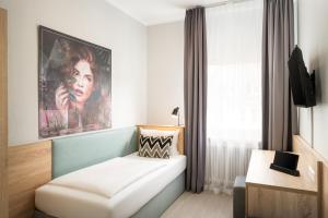 Postel nebo postele na pokoji v ubytování Arthotel ANA Eden