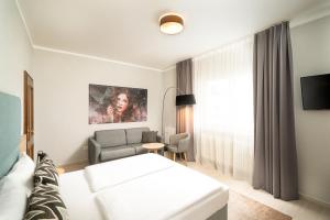 Postel nebo postele na pokoji v ubytování Arthotel ANA Eden
