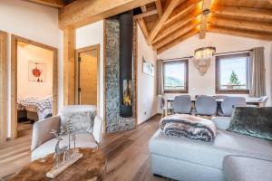 a living room with a couch and a table at Apartment Lizay Morzine - by EMERALD STAY in Morzine
