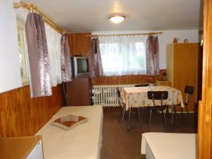 a room with a table and a dining room at Apartmán - Dagmar in Svoboda nad Úpou