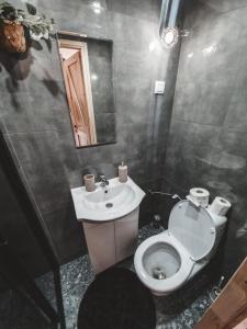 a bathroom with a white toilet and a sink at Domek pod Lawendą, Roztocze in Rebizanty +18 photos