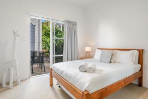 a bedroom with a bed with two towels on it at Quarterdeck Unit 2 - Lennox Head in Lennox Head
