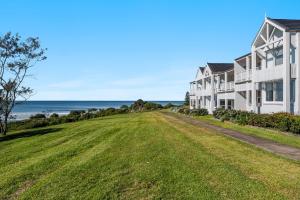 a row of houses with the ocean in the background at Quarterdeck Unit 2 - Lennox Head in Lennox Head