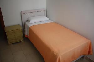 a small bedroom with a bed and a night stand at TETI Rooms in Francavilla Fontana