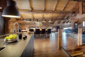 a kitchen and dining room with a dining table at Chalet Victorina - OVO Network in La Giettaz